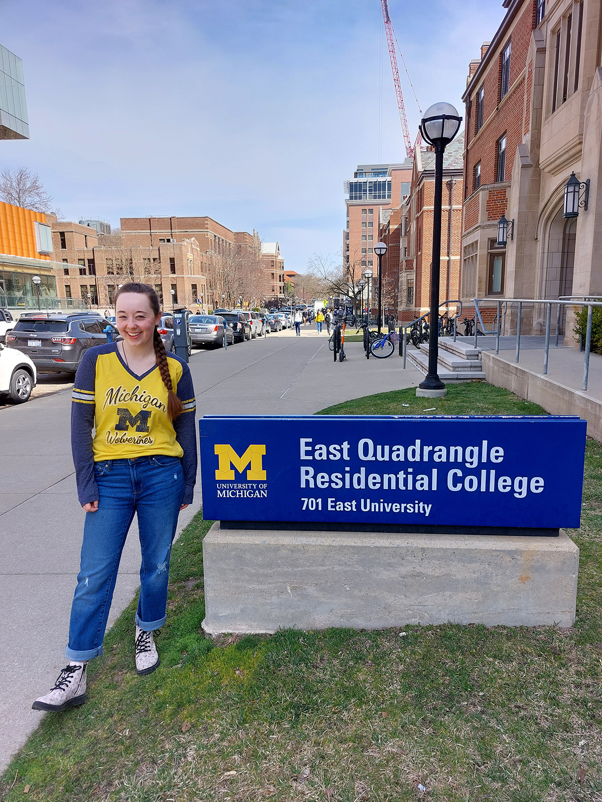 Standing in front of East Quad Residential College sign