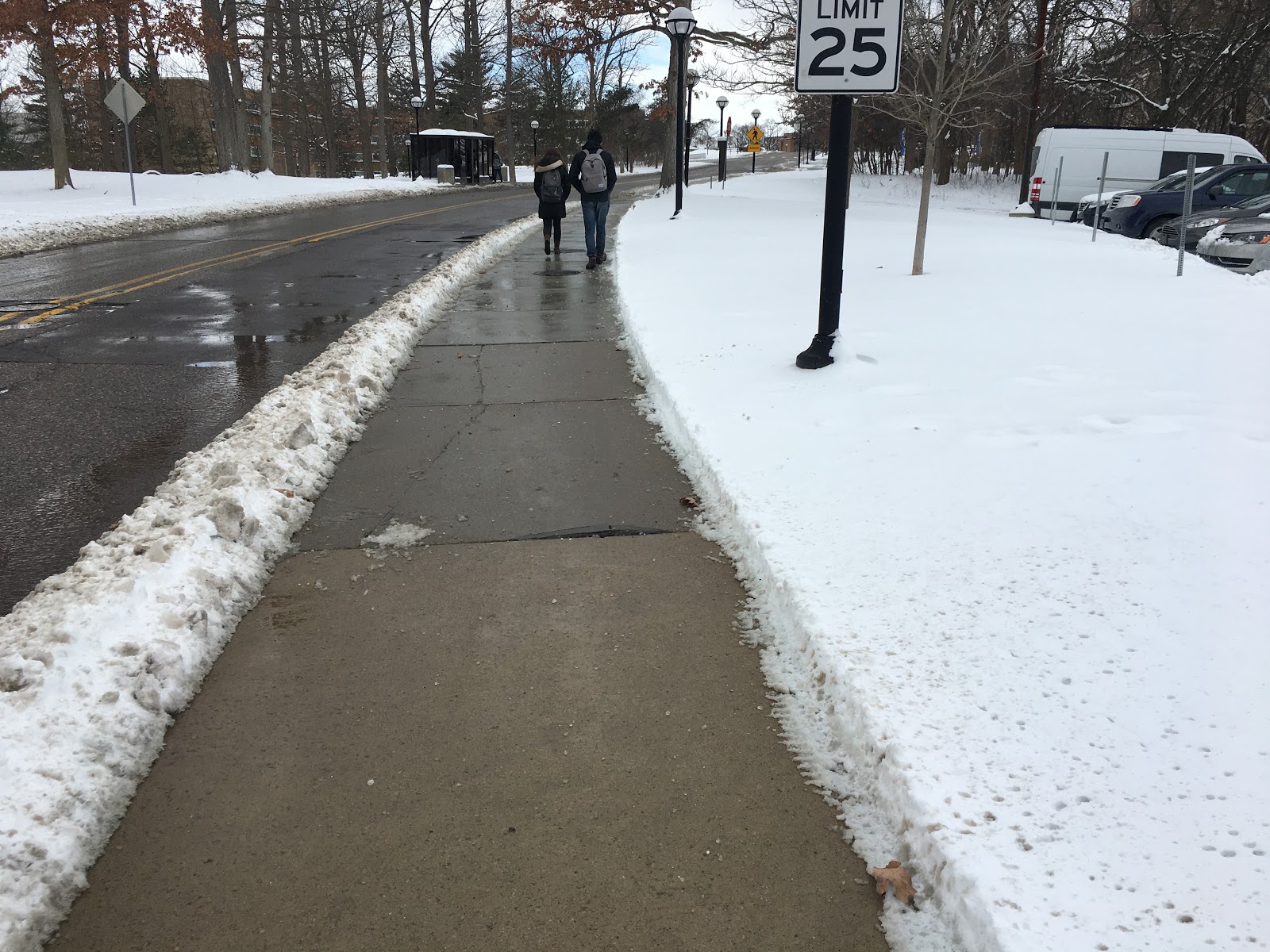 People walking on the sidewalk after snowfall