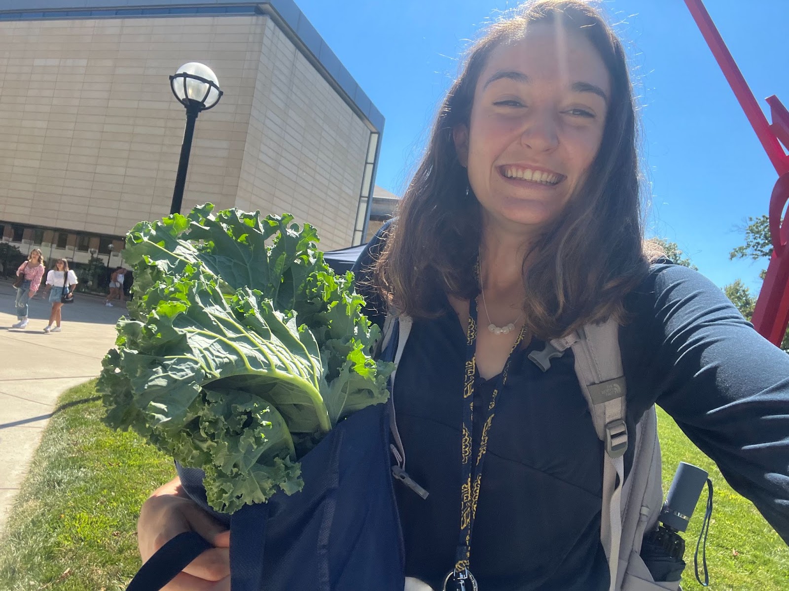 Me smiling with kale, courtesy of the Campus Farm Stand