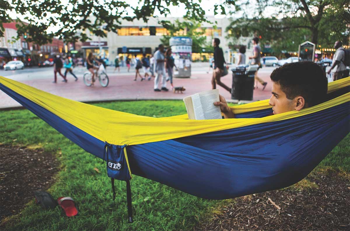 student reading a book in a hammock