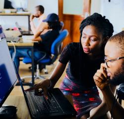 An instructor helping a student on a computer