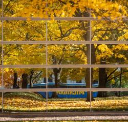 Yellow fall leaves reflected in the glass exterior of the Power Center