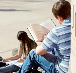 Two students reading outdoors