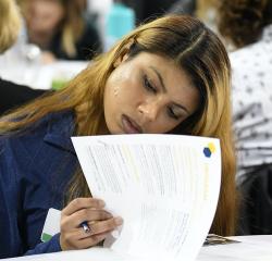 A student reviewing papers while in class