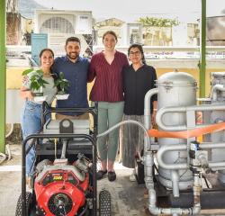 A group of students and a professor standing over a generator in Puerto Rico