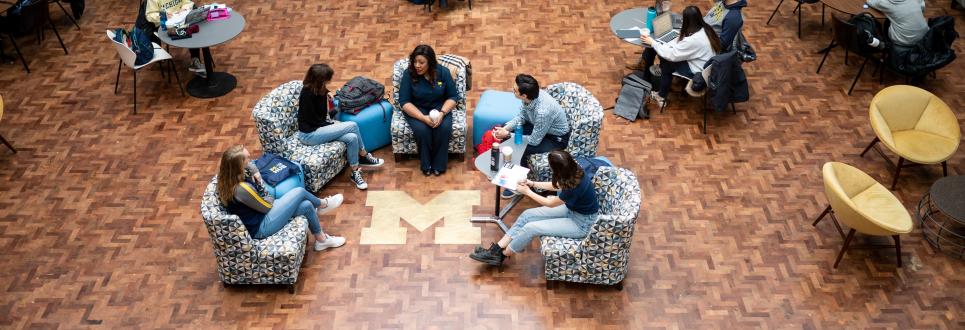 A faculty member speaking with a group of students