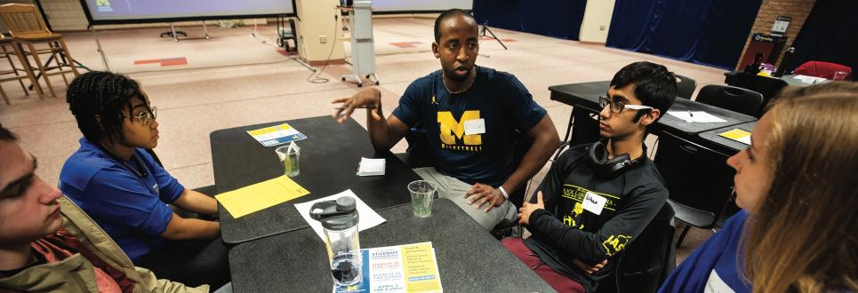 A group of students talking around a table