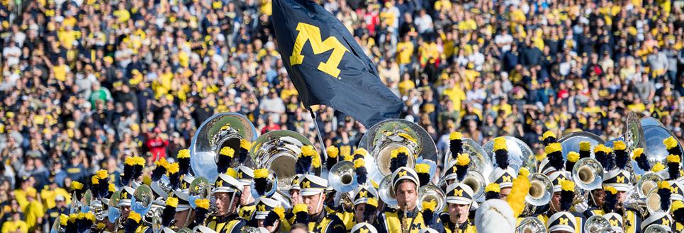 The Michigan Marching Band plays on the field