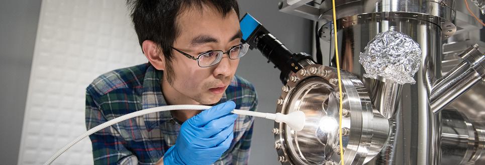 A male engineering student examines a machine