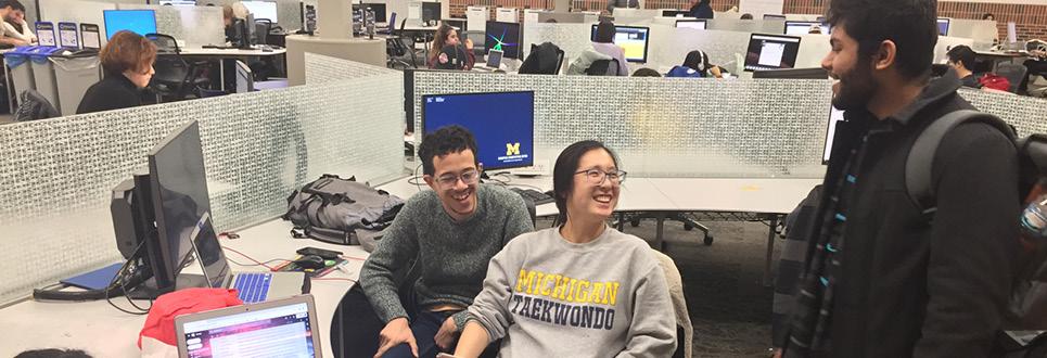 Students converse in the Fish Bowl computer lab