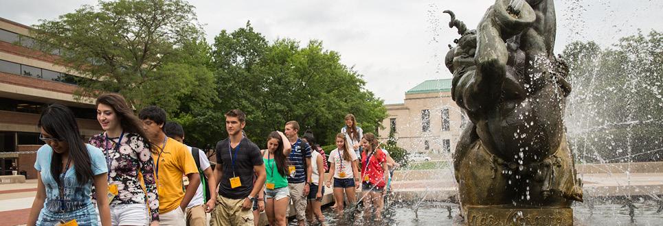 New students walk through the fountain at orientation