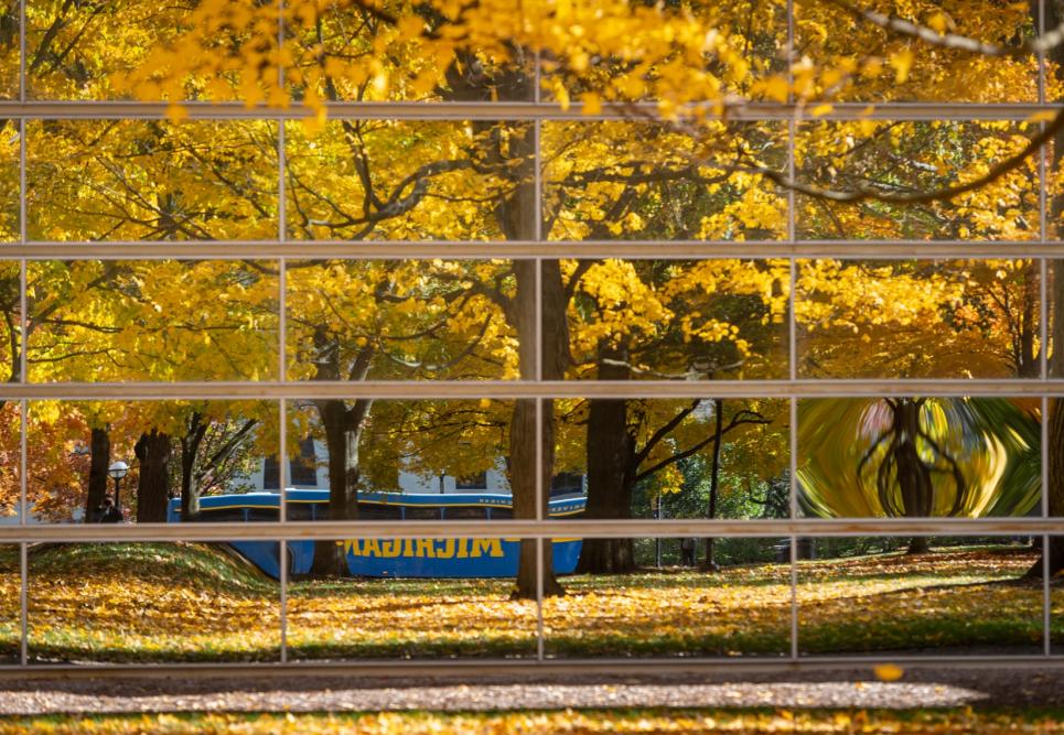 A bus reflected by windows in fall