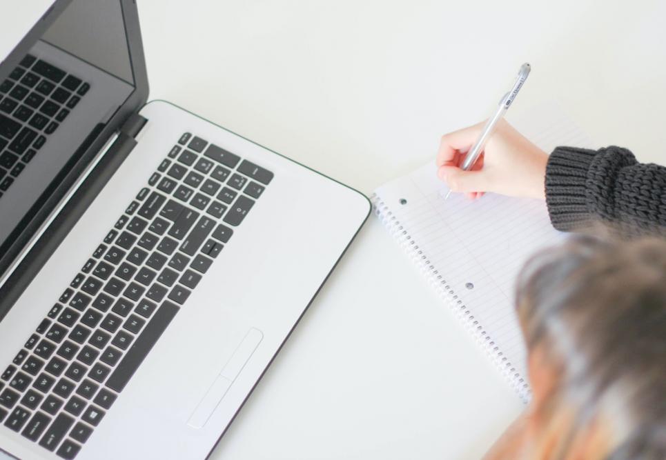 A laptop and a student