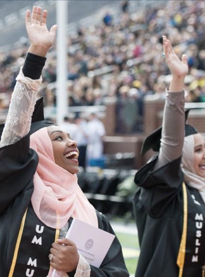 person waving at a graduation ceremony